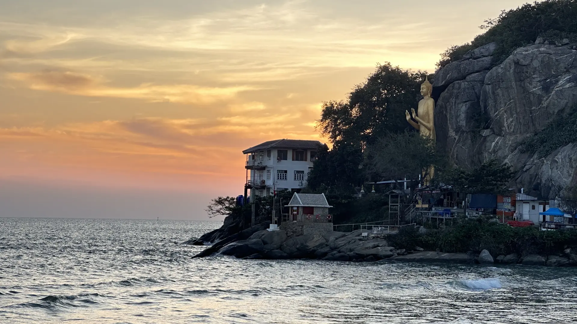 Golden sunrise behind the rocks of Khao Takiab